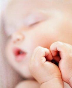 Close-up of a newborn baby with parent
